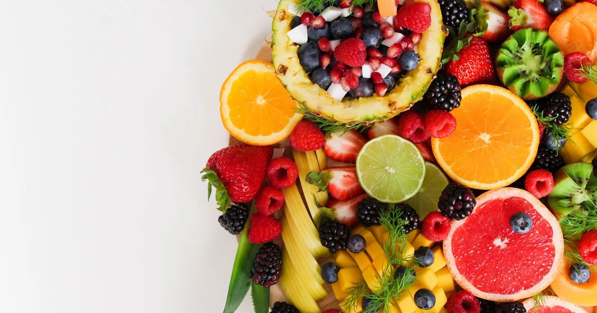 Bowls of nuts, fruit, yogurt and cut vegetables as healthy snack options