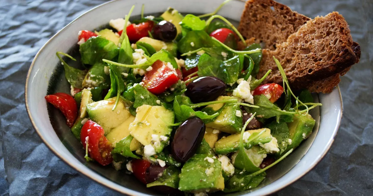 Balanced meal divided into protein, whole grains, and healthy fats on a plate