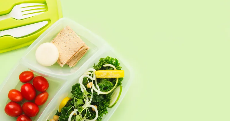 Lunch box with separate compartments for salad ingredients