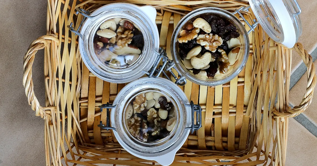 Jars of mixed nuts and dried fruit in a basket