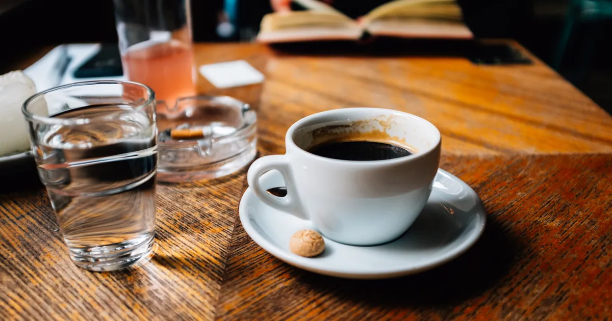 A cup of black coffee on a table