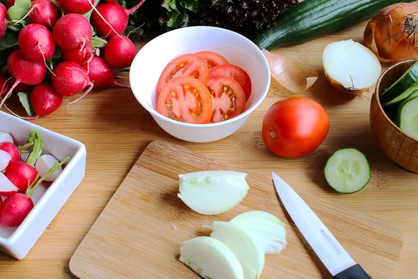 Fresh salad ingredients being prepared in a home kitchen