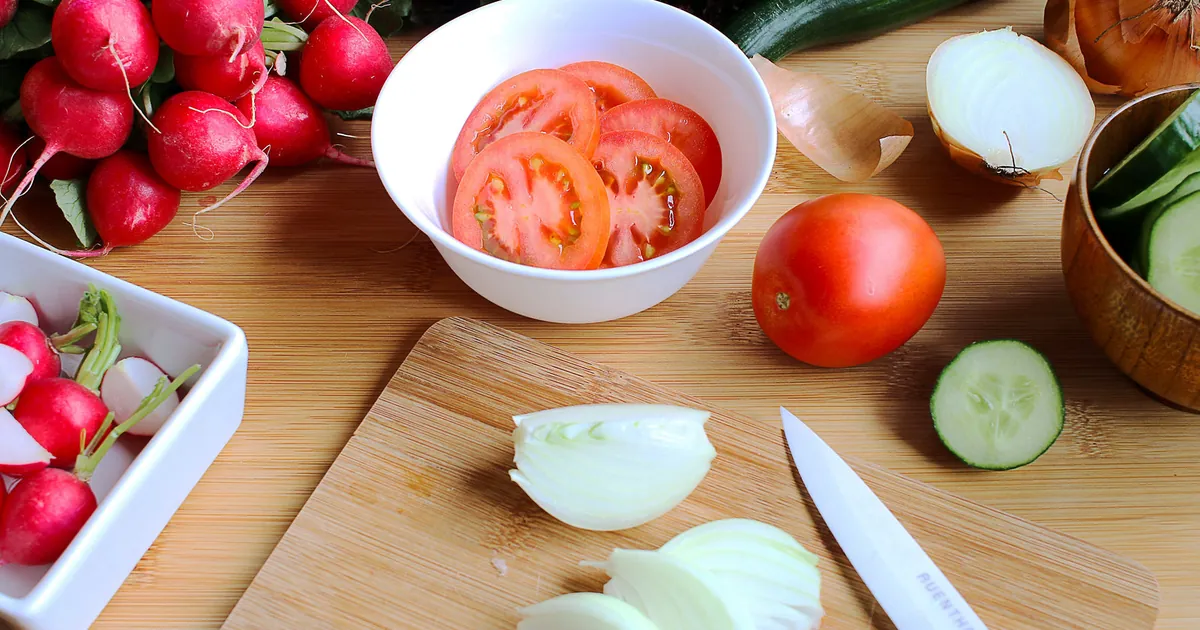 Fresh salad ingredients being prepared in a home kitchen