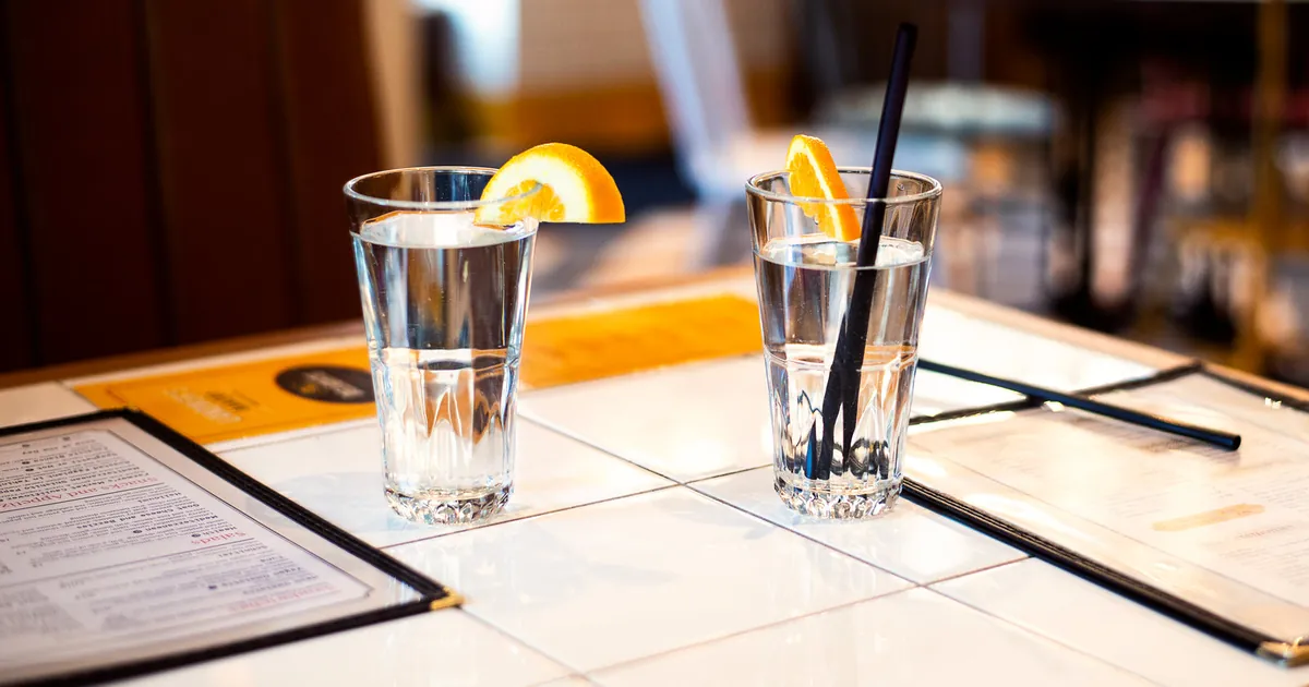 Glasses and a carafe of fresh water on a table